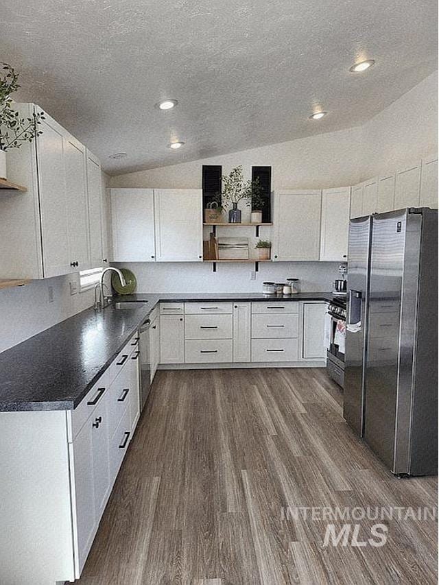 297 N 4228 E, Rigby, ID 83442 - kitchen with appliances with stainless steel finishes, open shelves, dark wood-style floors, a textured ceiling, and dark countertops