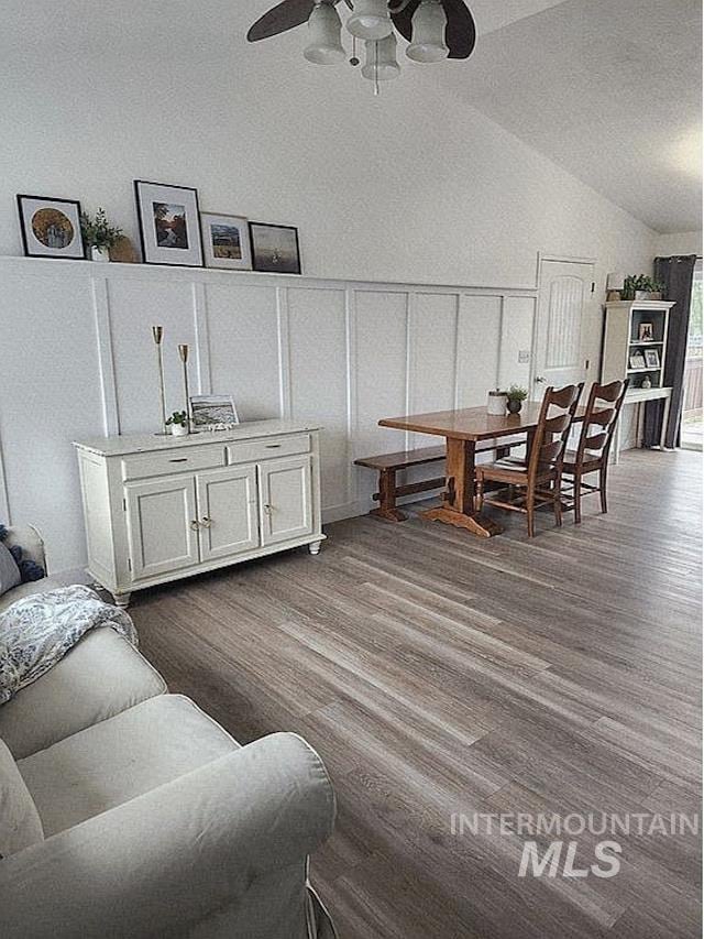 297 N 4228 E, Rigby, ID 83442 - living area featuring dark wood-style floors, a ceiling fan, a decorative wall, and lofted ceiling