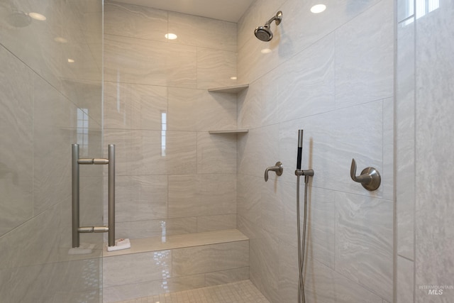 bathroom with tiled shower