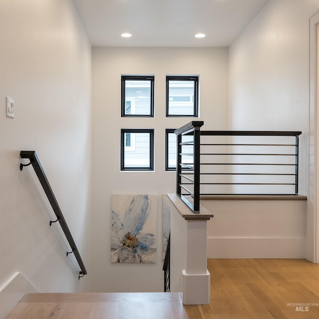 stairs featuring hardwood / wood-style flooring