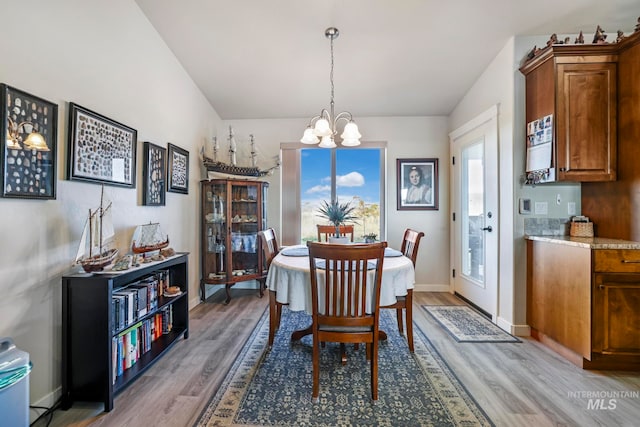 dining room featuring hardwood / wood-style floors and a notable chandelier