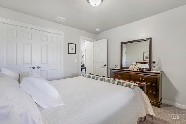 bedroom featuring a closet and light carpet