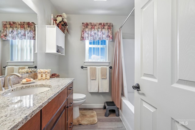 full bathroom featuring toilet, shower / bath combination with curtain, vanity, and wood-type flooring