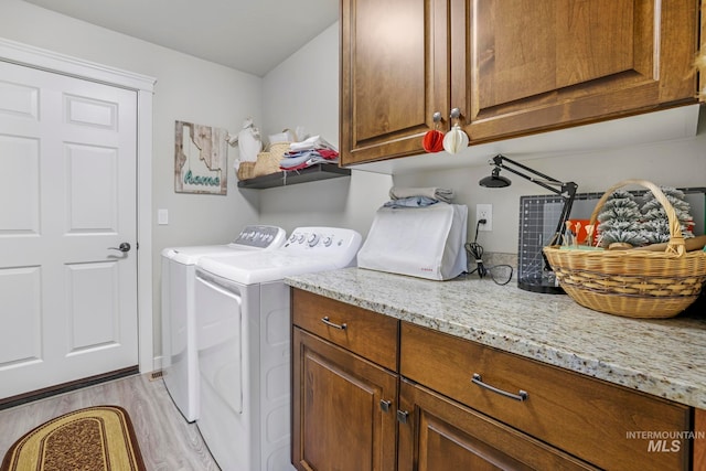 washroom with light hardwood / wood-style floors, cabinets, and independent washer and dryer