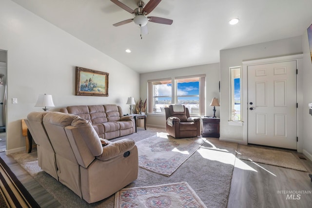 living room featuring lofted ceiling, hardwood / wood-style flooring, and ceiling fan