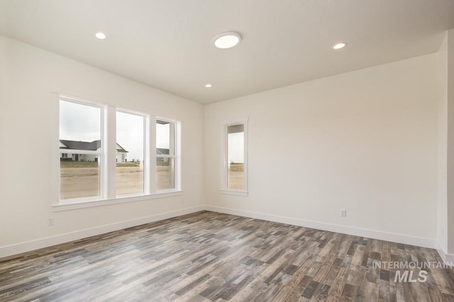 spare room featuring hardwood / wood-style floors