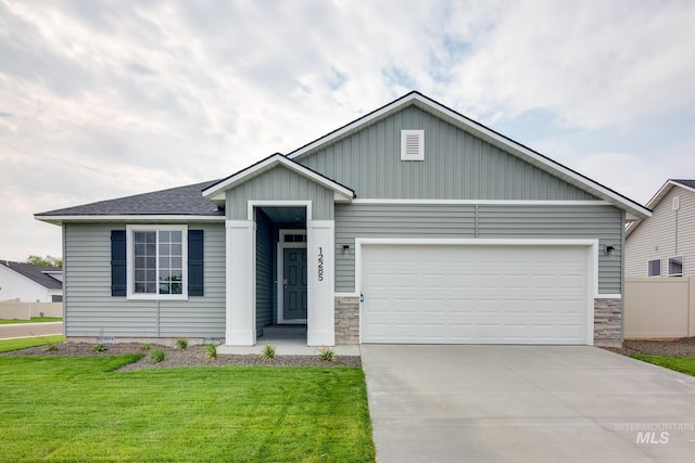 view of front of home with a garage and a front yard