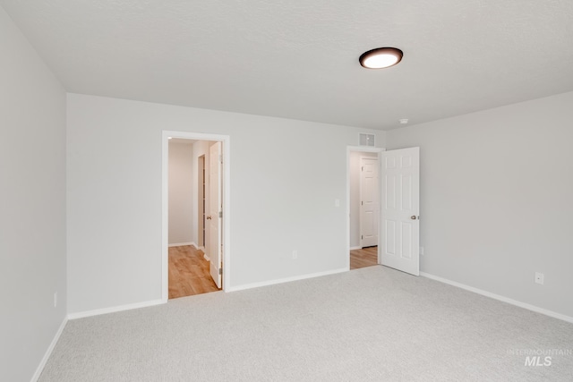 unfurnished room with light colored carpet