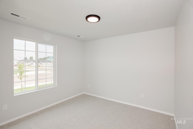 unfurnished room featuring carpet