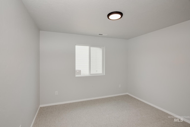 unfurnished room featuring carpet