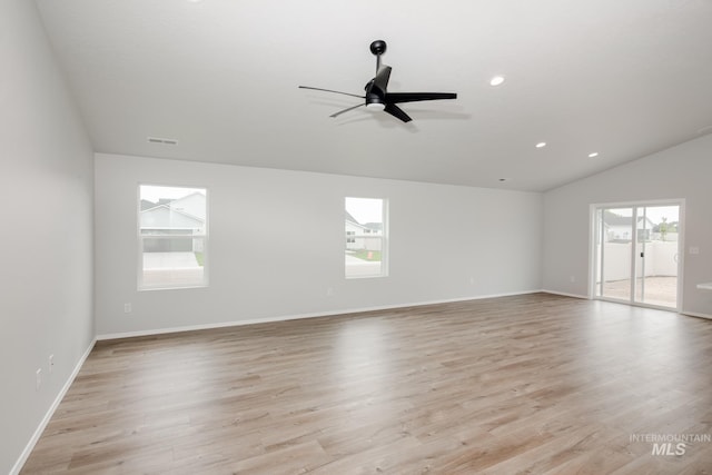 empty room with vaulted ceiling, light hardwood / wood-style flooring, and ceiling fan