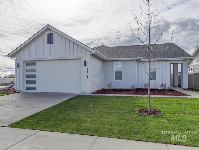 12653 W Pine Grass St, Star, ID 83669 - view of front of home featuring board and batten siding, a front lawn, driveway, and a garage