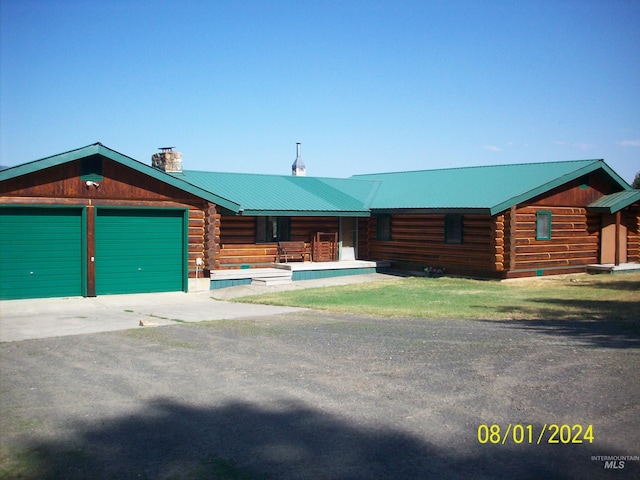 1050 Maxwell Ln, Elk City, ID 83525 - view of green lawn with driveway and an attached garage