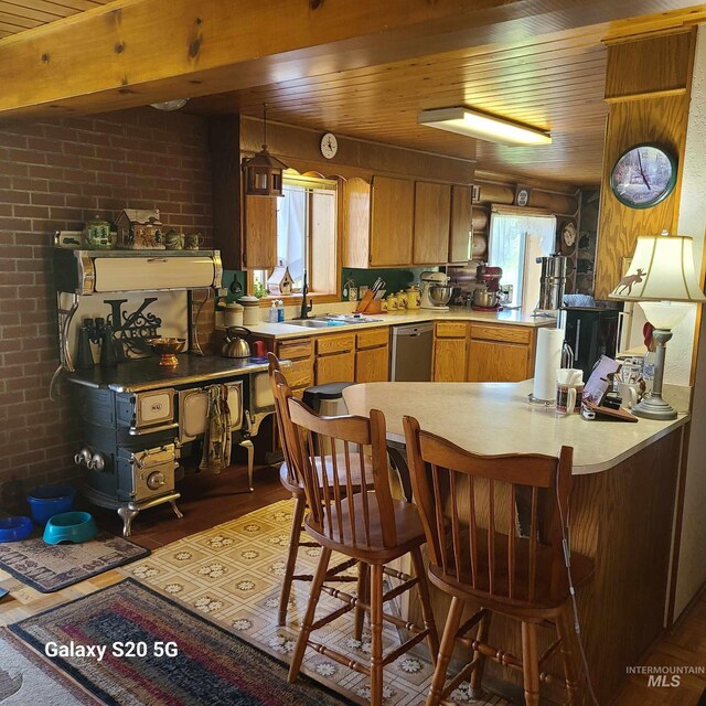 1050 Maxwell Ln, Elk City, ID 83525 - kitchen with dishwasher, wooden ceiling, light countertops, a sink, and brown cabinets