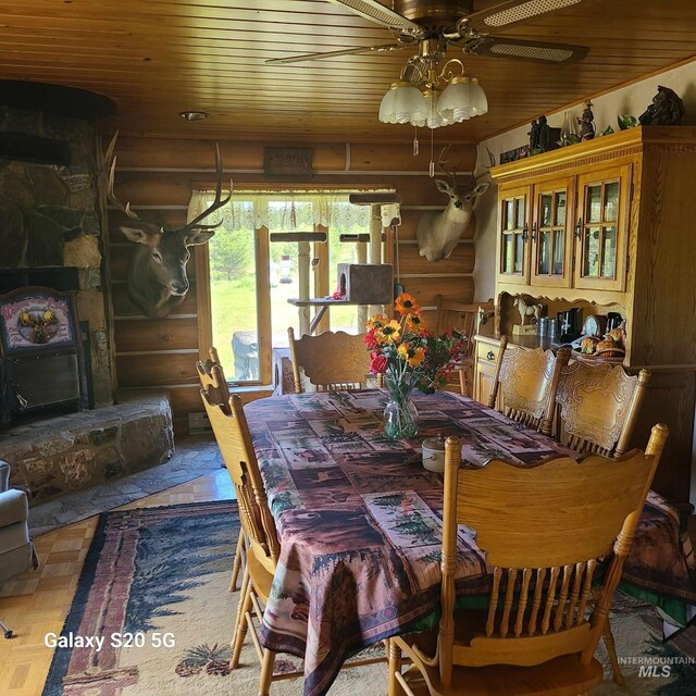 1050 Maxwell Ln, Elk City, ID 83525 - dining area with rustic walls, wood ceiling, plenty of natural light, and wood finished floors