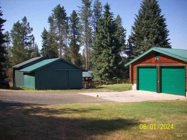 1050 Maxwell Ln, Elk City, ID 83525 - back of property featuring log exterior, a lawn, metal roof, a chimney, and a rural view