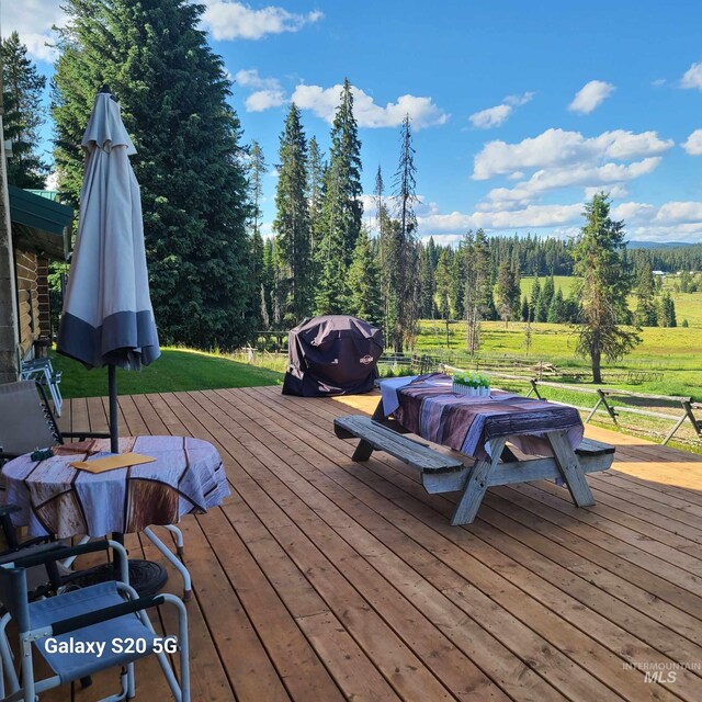 1050 Maxwell Ln, Elk City, ID 83525 - rear view of house with log siding, a chimney, and a yard