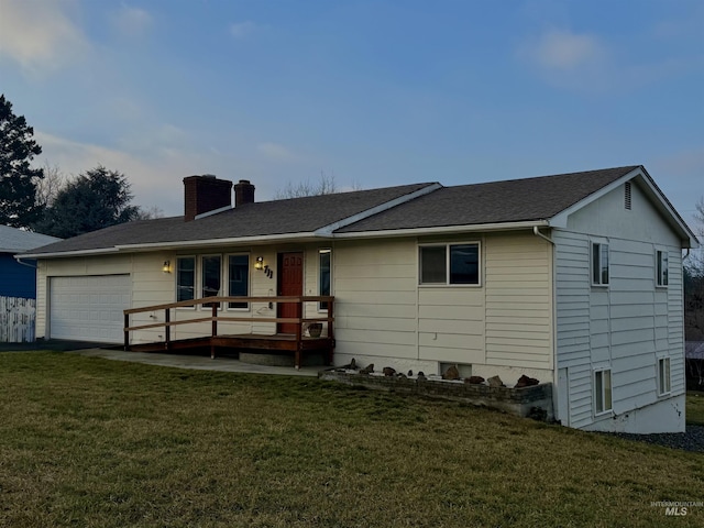 view of front of property with an attached garage, roof with shingles, a chimney, and a front yard