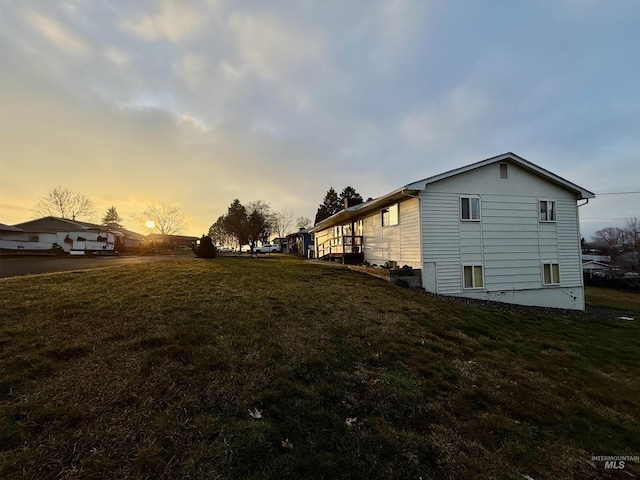 view of property exterior with a lawn