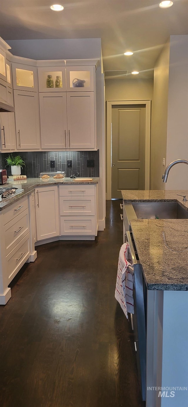 kitchen featuring sink, decorative backsplash, and white cabinets