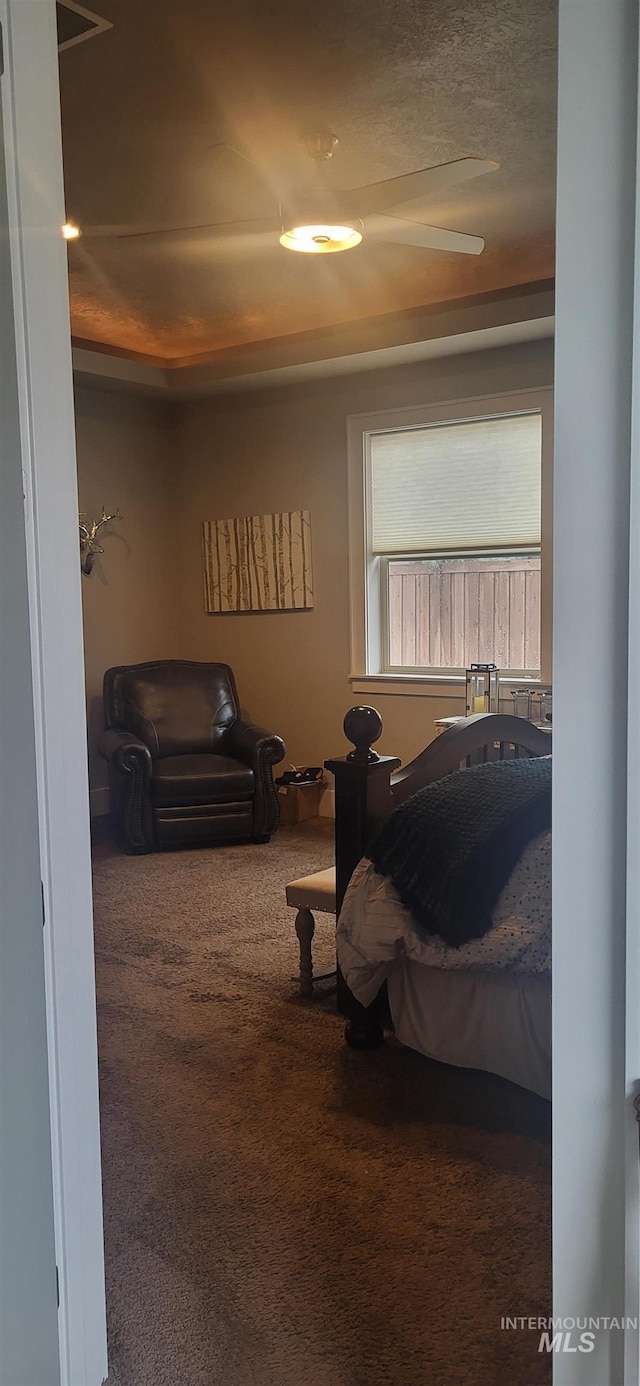 bedroom with carpet floors and a textured ceiling