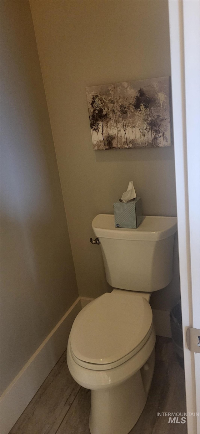 bathroom featuring hardwood / wood-style flooring and toilet