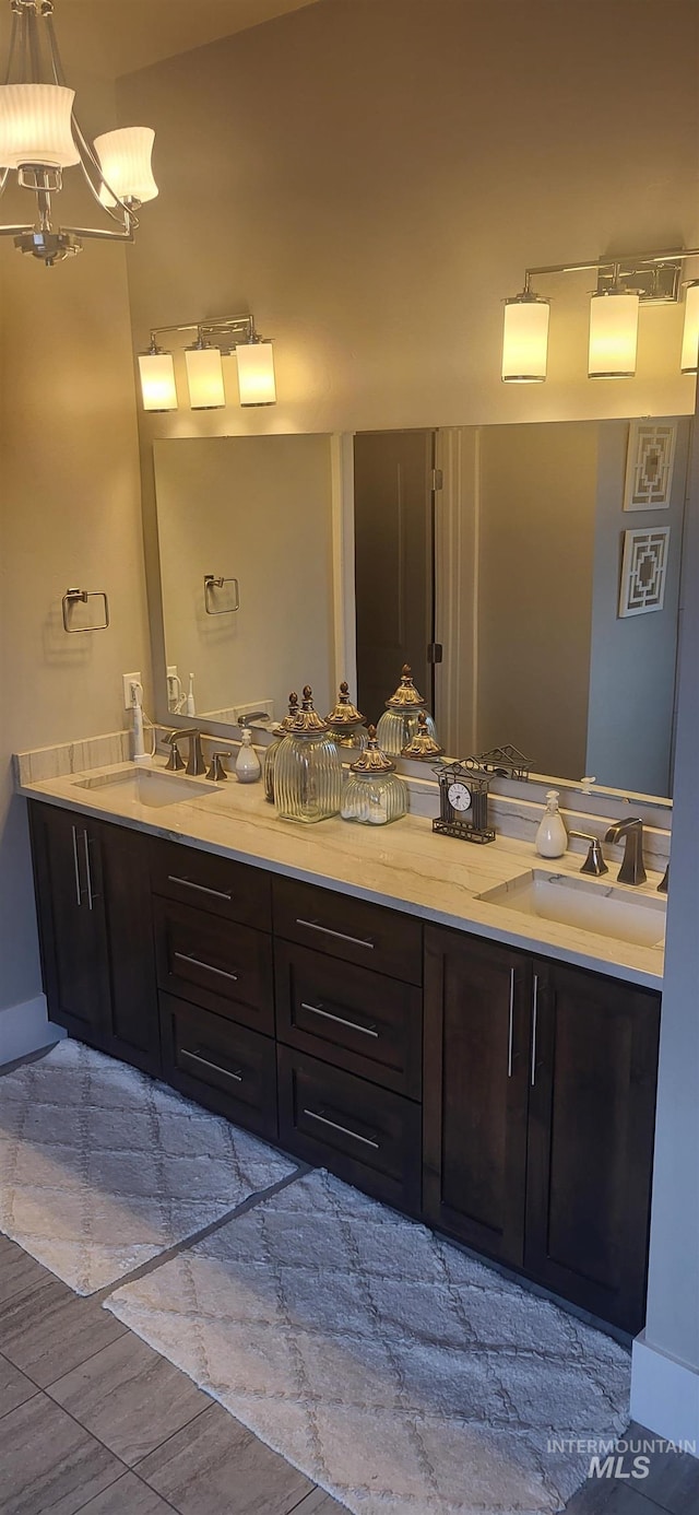 bathroom featuring vanity, a chandelier, and wood-type flooring