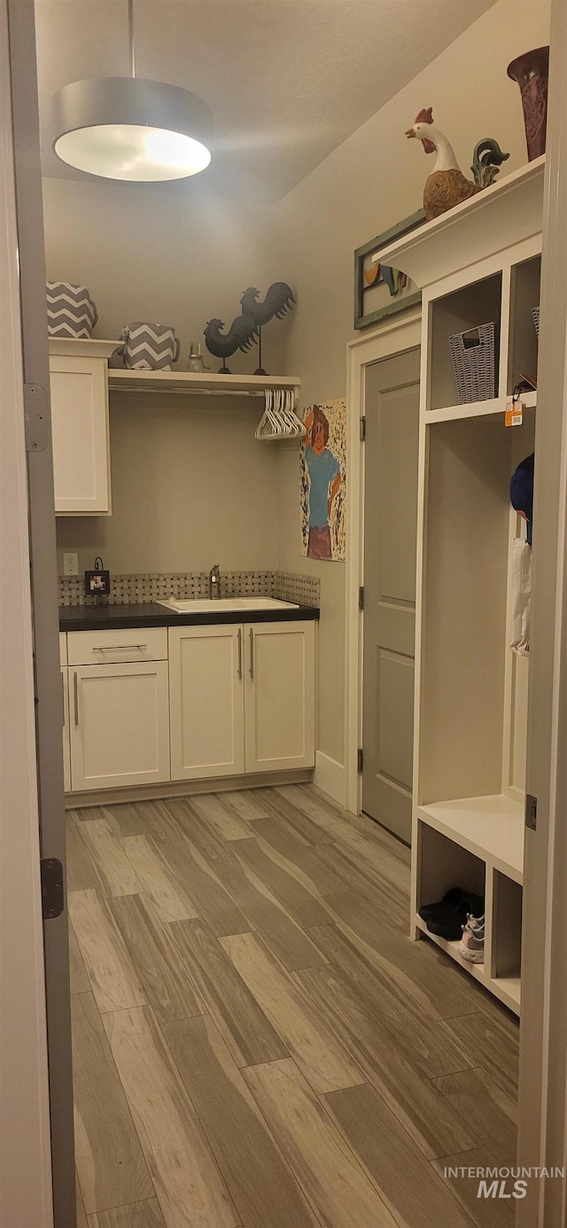 mudroom featuring sink and light wood-type flooring