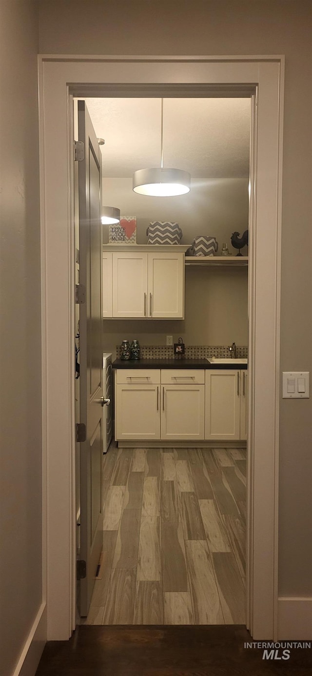 interior space featuring sink and light hardwood / wood-style floors