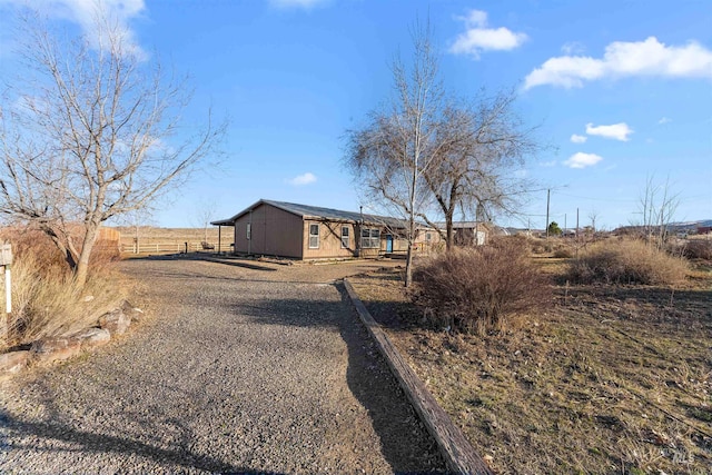 exterior space with a rural view and fence