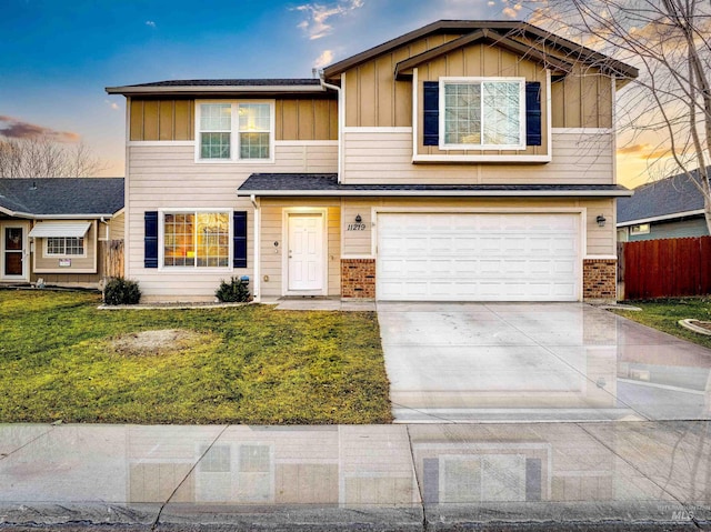 view of front facade with a garage and a lawn