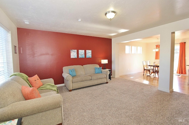 carpeted living room featuring a textured ceiling