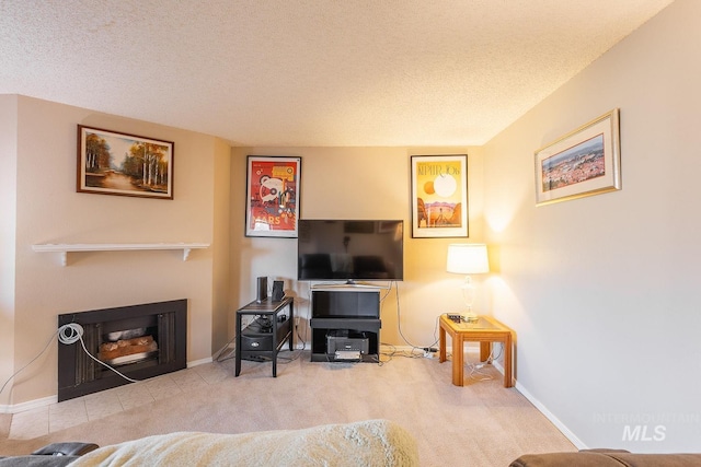 living room featuring light colored carpet and a textured ceiling