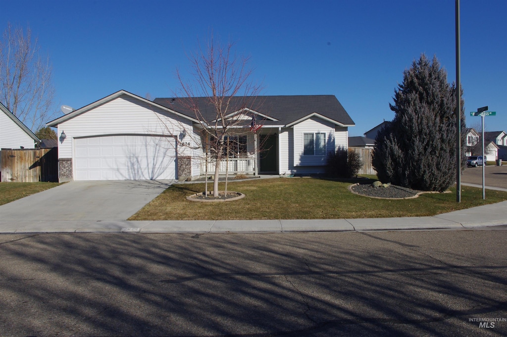 single story home featuring a front yard and a garage