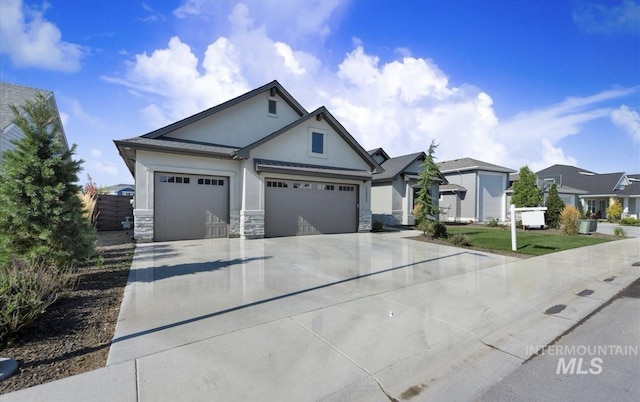ranch-style home featuring concrete driveway, stone siding, an attached garage, stucco siding, and a residential view