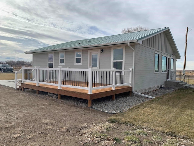 back of house with a wooden deck