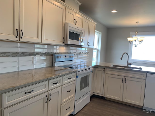 kitchen featuring pendant lighting, a notable chandelier, tasteful backsplash, white appliances, and dark hardwood / wood-style floors