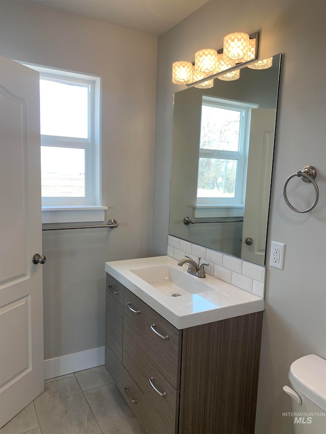 bathroom featuring vanity, tile floors, and toilet