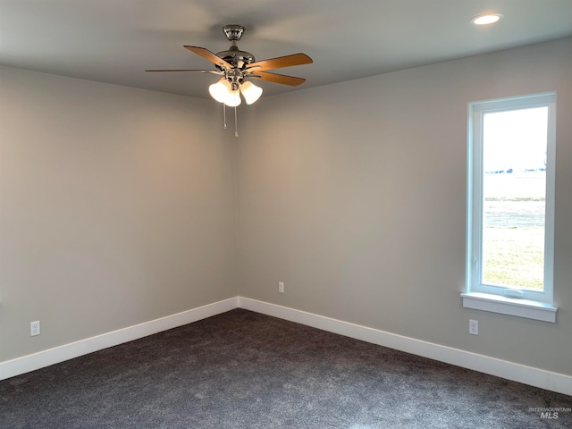 carpeted spare room with ceiling fan