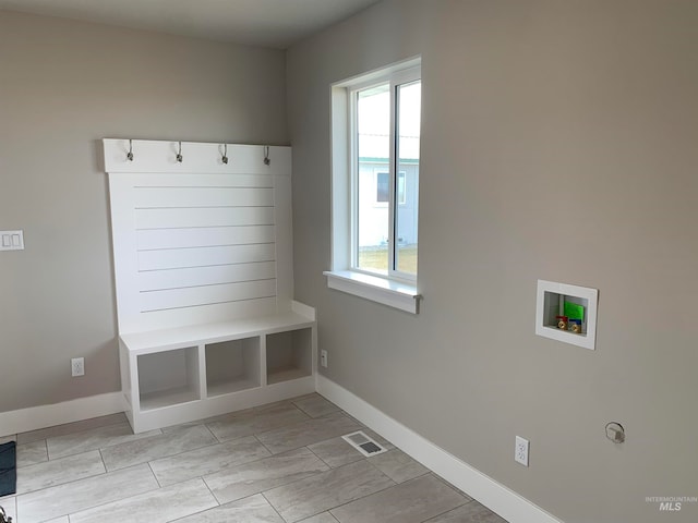 mudroom with plenty of natural light and light tile flooring