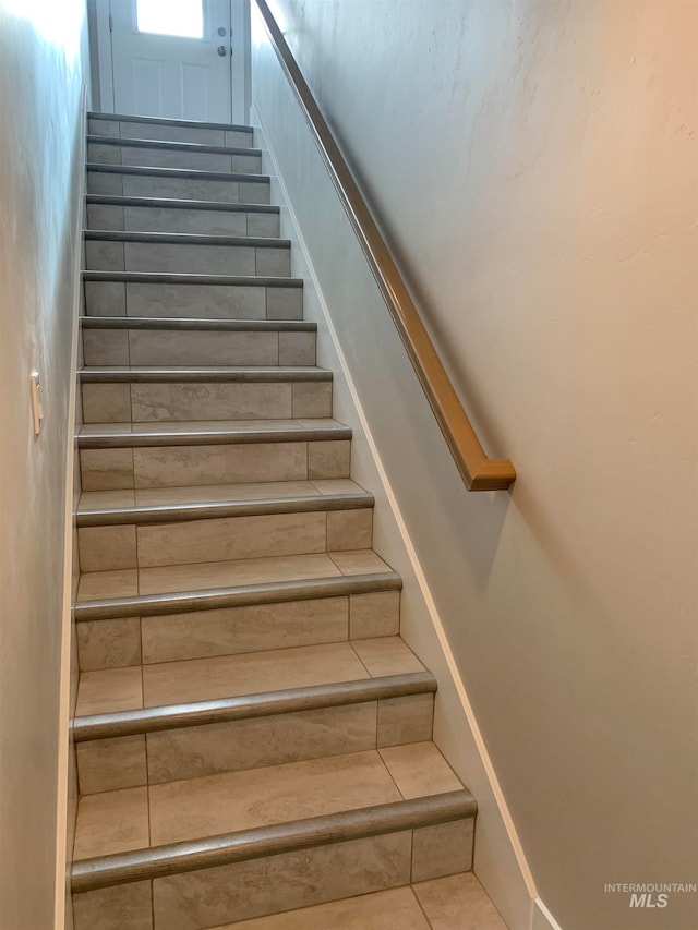 stairs with light tile floors