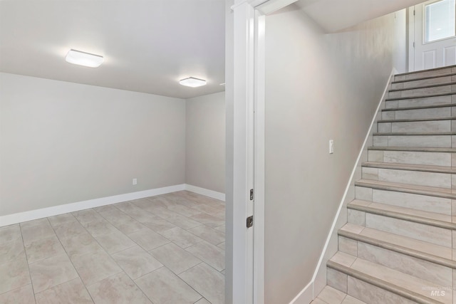 stairs featuring light tile floors