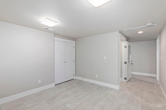 interior space with light tile floors and a closet