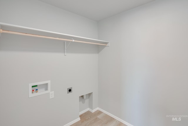 washroom featuring electric dryer hookup, light hardwood / wood-style floors, and hookup for a washing machine