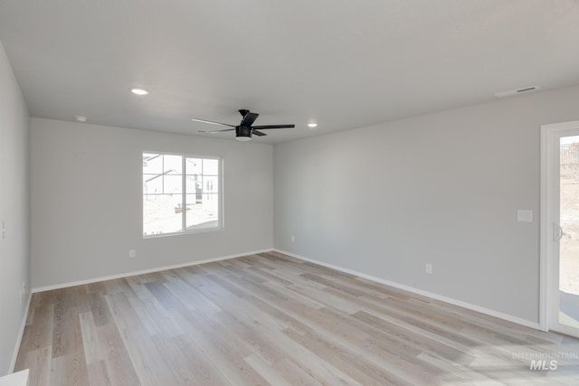 unfurnished room featuring ceiling fan, a wealth of natural light, and light hardwood / wood-style flooring