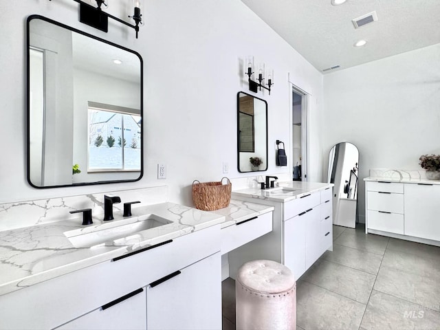full bath with two vanities, recessed lighting, tile patterned floors, and a textured ceiling