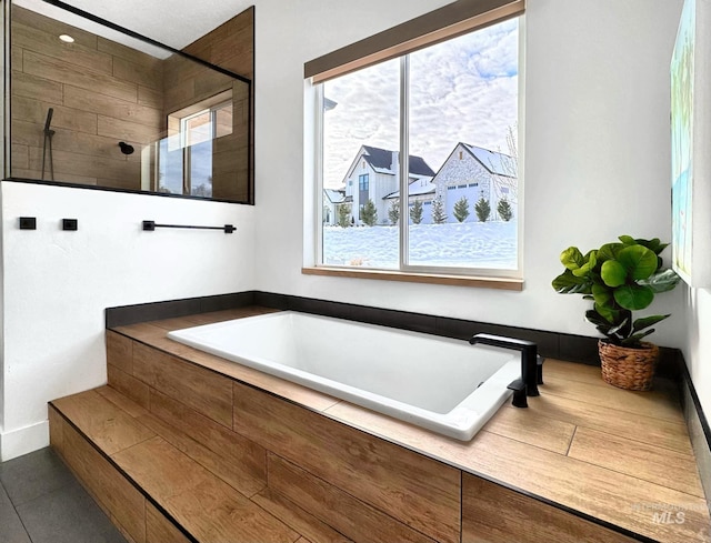 bathroom with a walk in shower, a bath, and tile patterned flooring