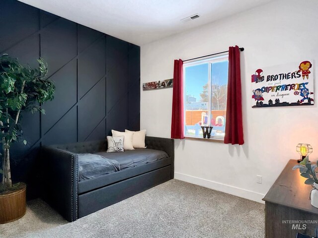 living area featuring carpet flooring and baseboards