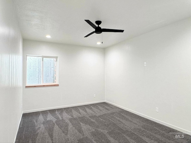 unfurnished room with dark colored carpet, ceiling fan, baseboards, and recessed lighting