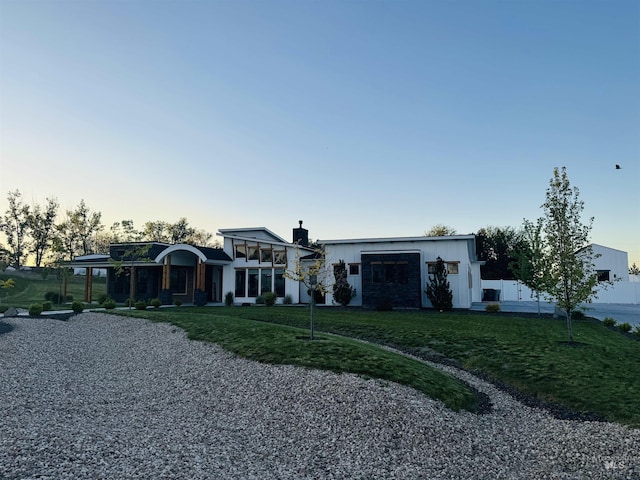 view of front of house with a garage and a front yard